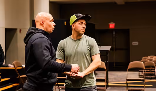 Two men on stage speaking